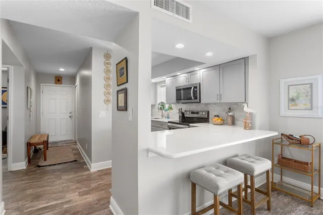 a view of kitchen with cabinets and wooden floor
