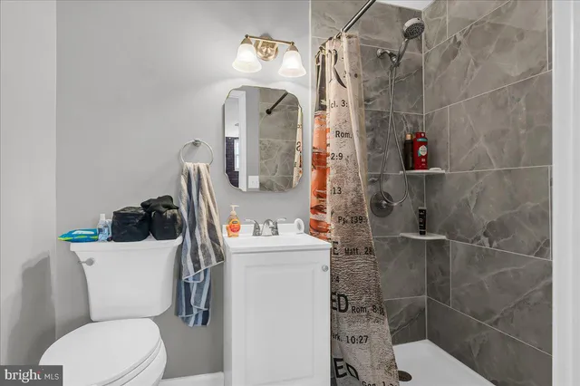 a bathroom with a toilet and a shower