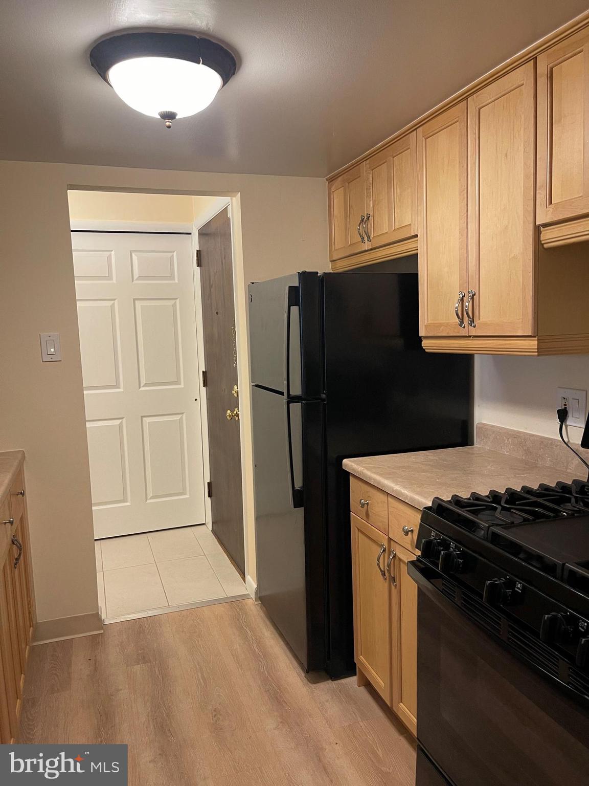 181 Drummers Lane, Unit 181 Wayne, PA 19087 - Photo 3 of 5 a kitchen with a refrigerator stove and cabinets