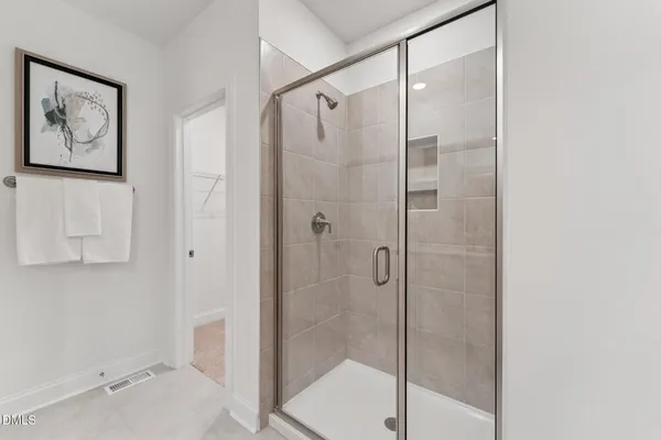 a bathroom with a shower and a sink