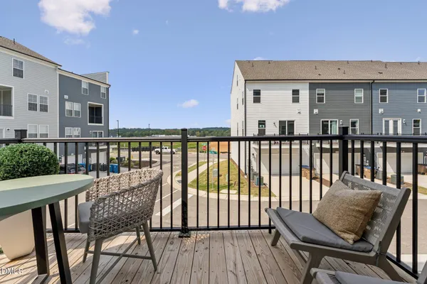 a view of a chair and table on the roof deck