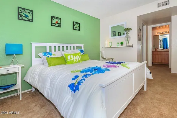 a bedroom with a bed and a table