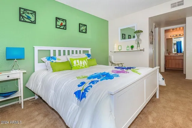 a bedroom with a bed and a table