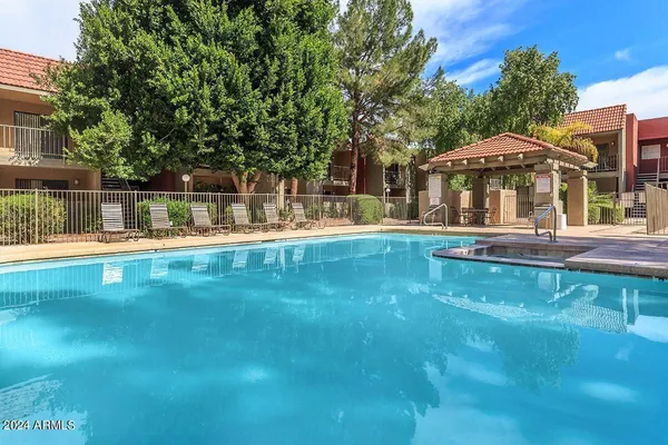 a view of a swimming pool with an outdoor seating