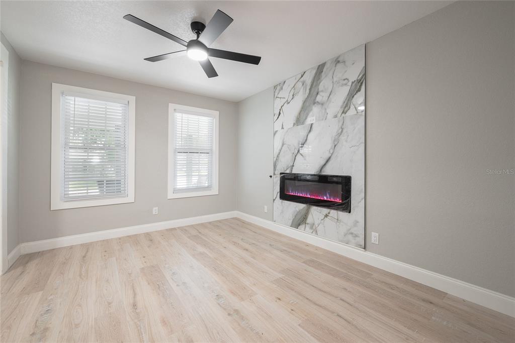 922 Delaware Avenue St. Cloud, FL 34769 - Photo 6 of 31 a view of an empty room with wooden floor and a window