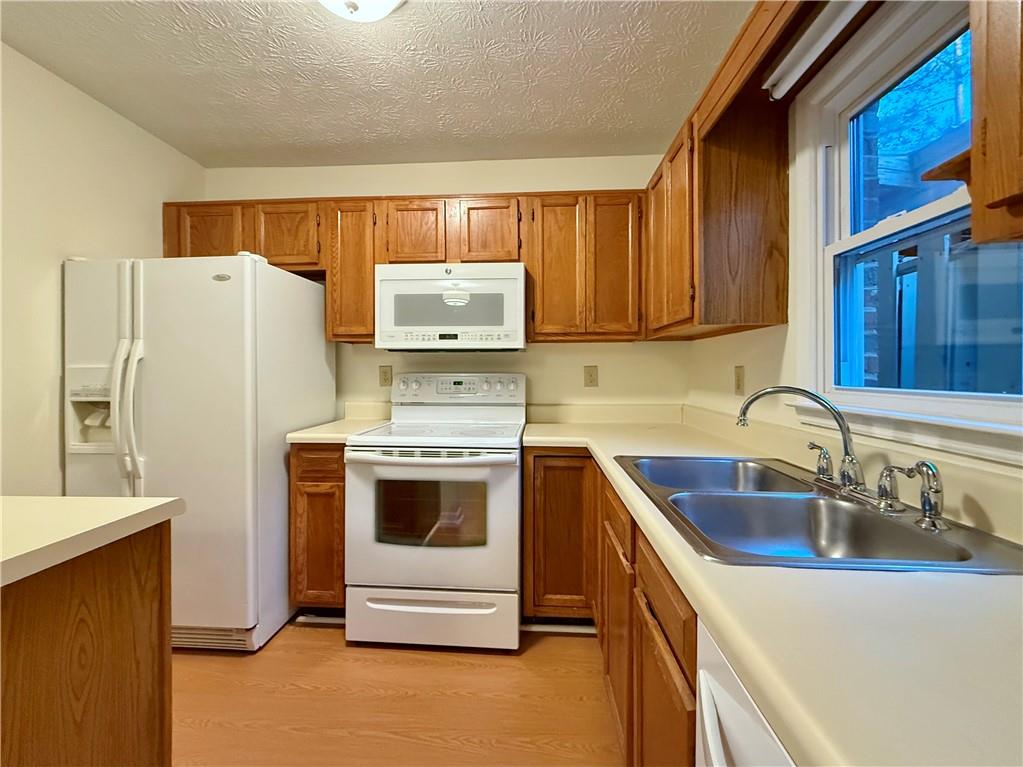 3533 Mulberry Way Duluth, GA 30096 - Photo 12 of 29 a kitchen with stainless steel appliances a refrigerator sink and stove