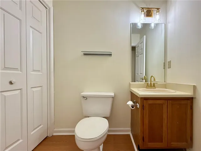 a bathroom with a toilet a sink and mirror