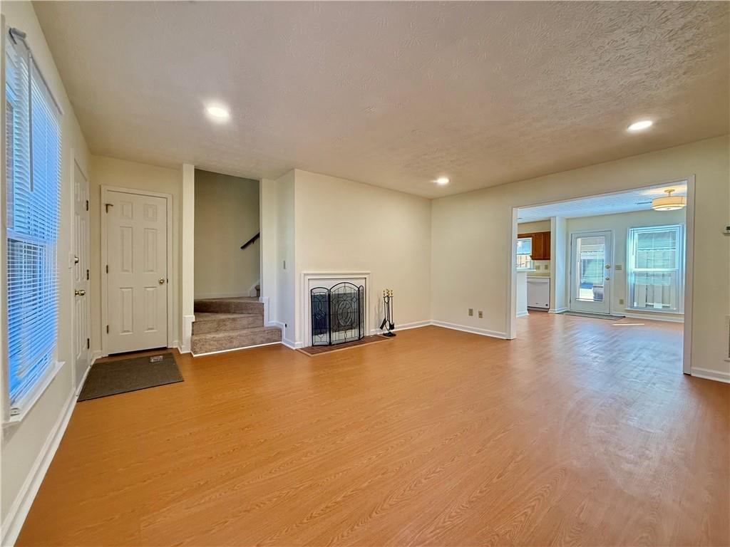 3533 Mulberry Way Duluth, GA 30096 - Photo 15 of 29 an empty room with fireplace and wooden floor