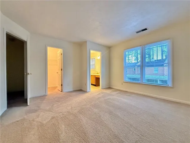 an empty room with windows and closet