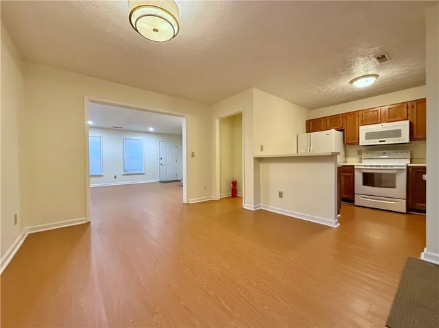 a view of a kitchen with a sink and a refrigerator