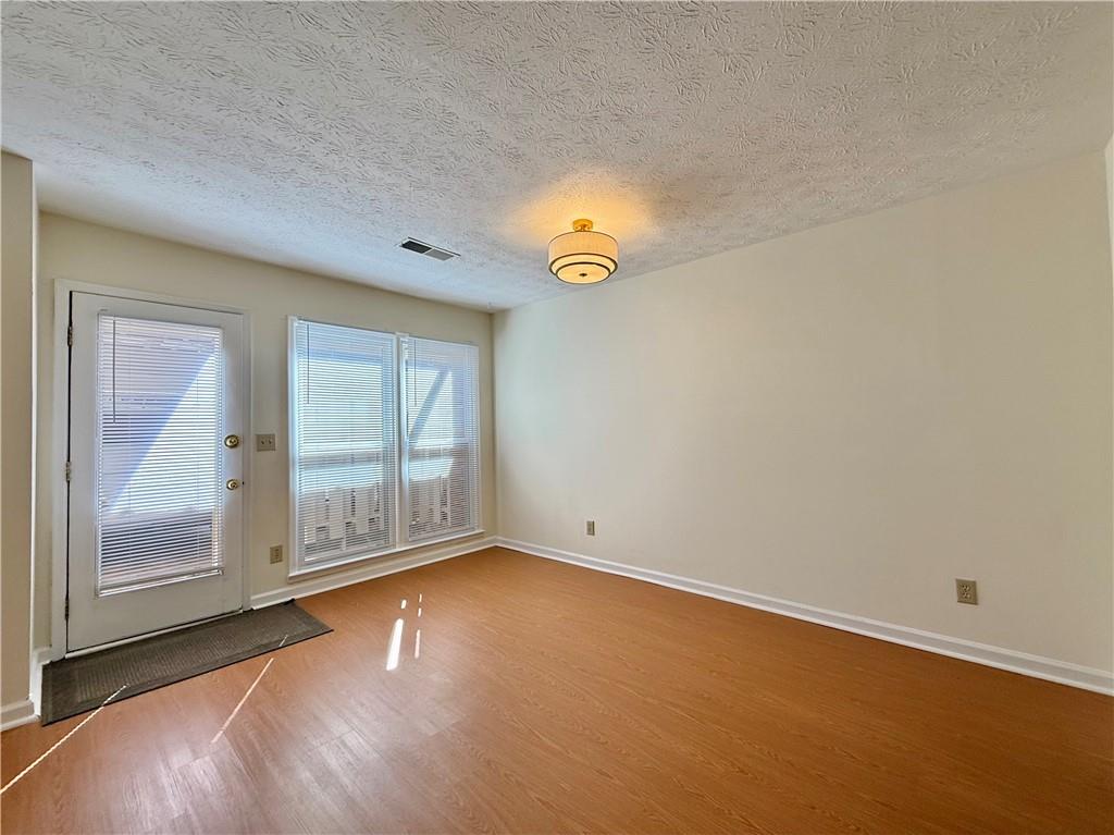 3533 Mulberry Way Duluth, GA 30096 - Photo 9 of 29 a view of empty room with wooden floor and fan