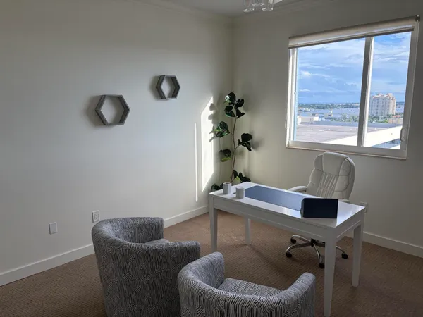 a work room with furniture and a window