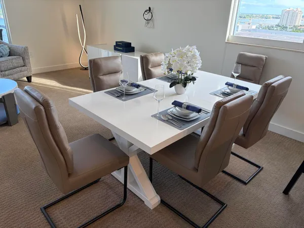 a dining room with furniture and wooden floor