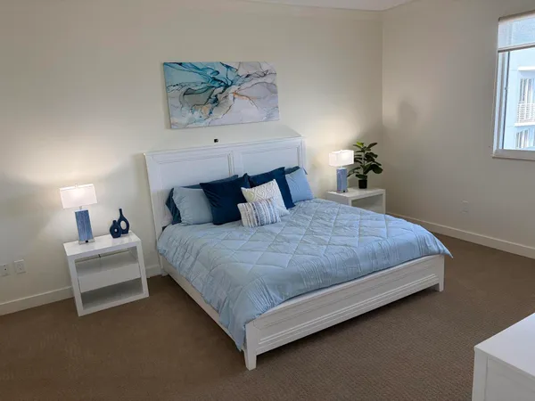 a bedroom with a bed and a chandelier