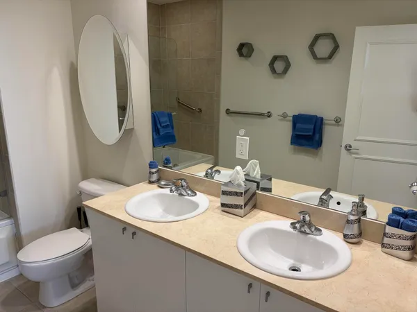a bathroom with a toilet sink and mirror