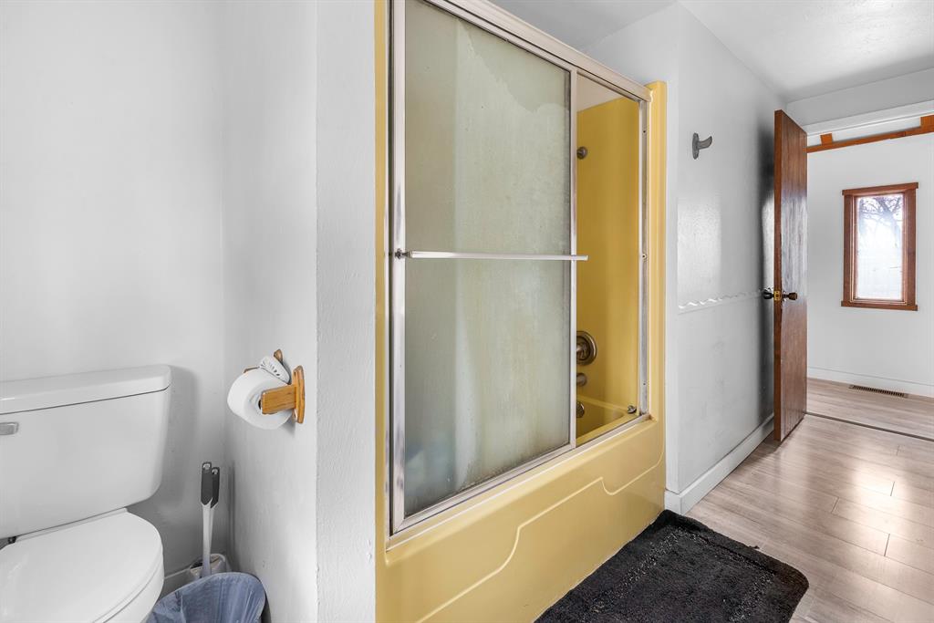 505 Alexander Road Stephenville, TX 76401 - Photo 12 of 29 a bathroom with a toilet and a shower