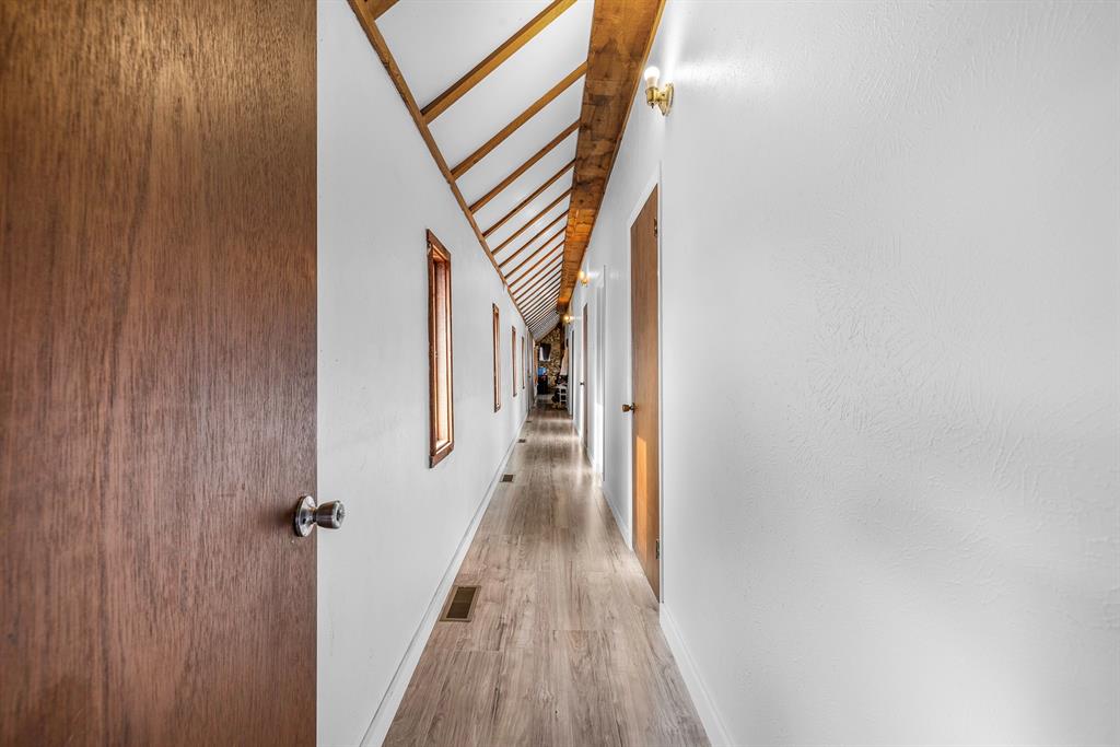 505 Alexander Road Stephenville, TX 76401 - Photo 16 of 29 a view of a hallway with wooden floor and staircase