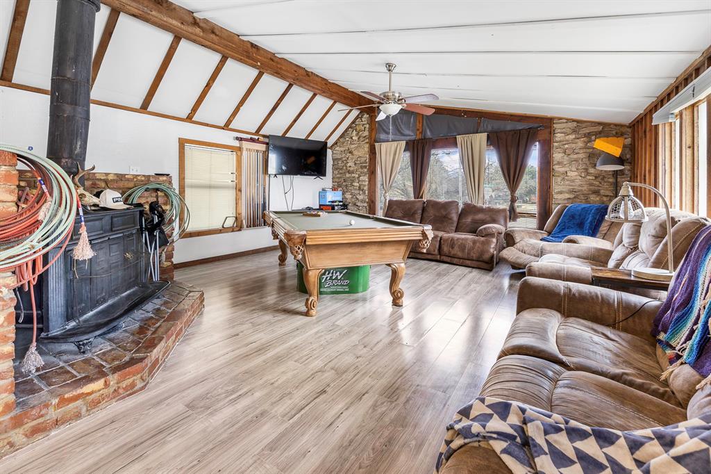 505 Alexander Road Stephenville, TX 76401 - Photo 5 of 29 a living room with furniture a fireplace and large windows