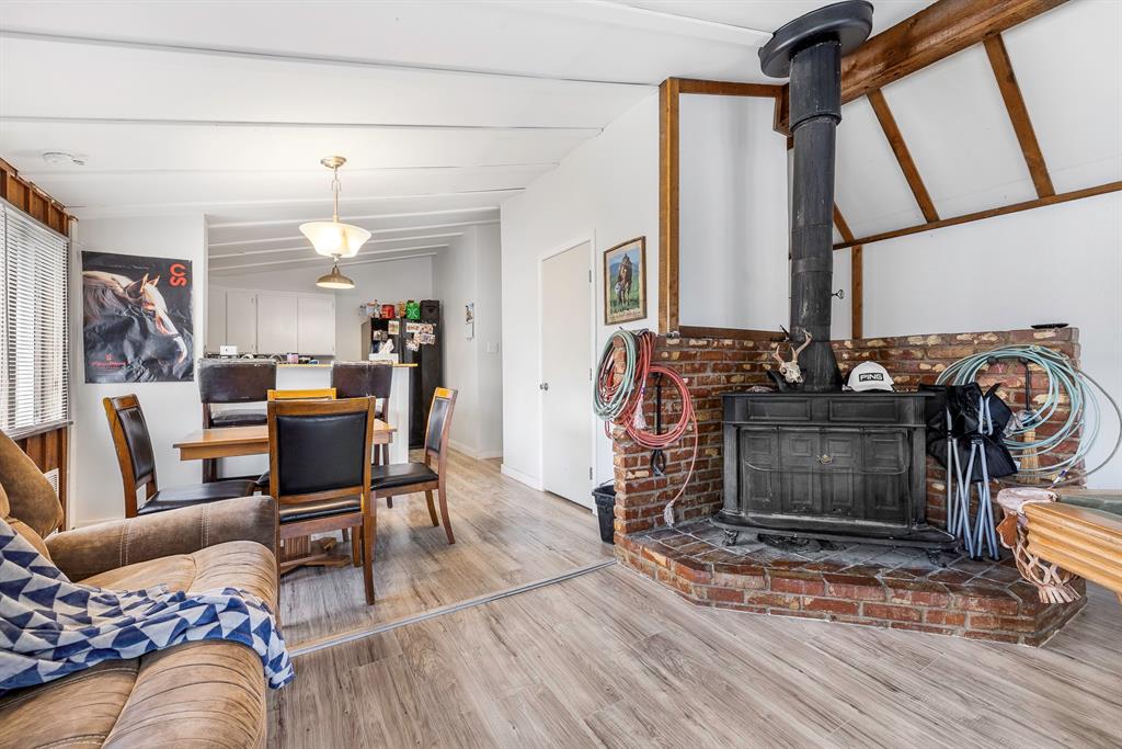 505 Alexander Road Stephenville, TX 76401 - Photo 7 of 29 a living room with furniture a fireplace and a floor to ceiling window