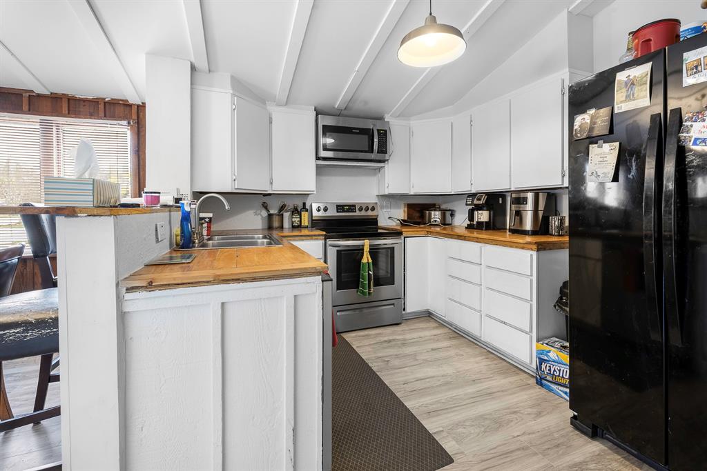 505 Alexander Road Stephenville, TX 76401 - Photo 10 of 29 a kitchen with a sink stove and refrigerator