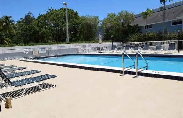 a view of a swimming pool with a lounge chair