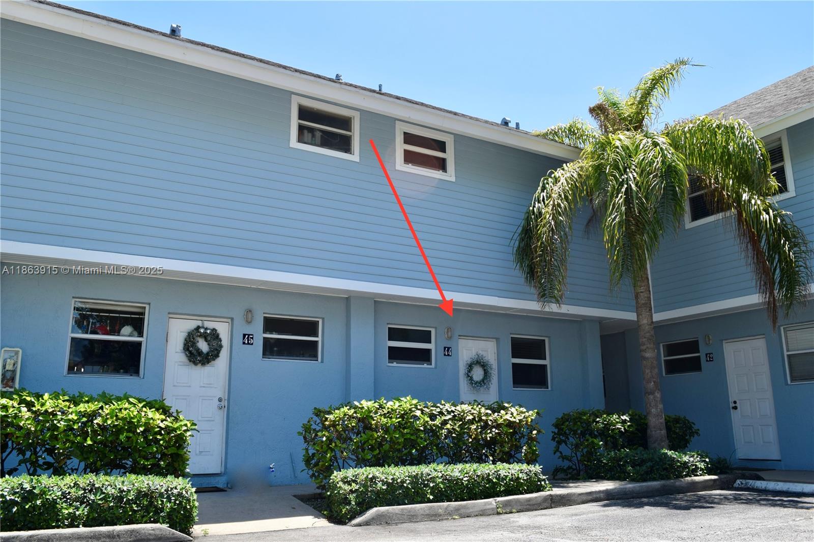 798 Crandon Boulevard, Unit 44B Key Biscayne, FL 33149 - Photo 12 of 13 a front view of a house with a yard