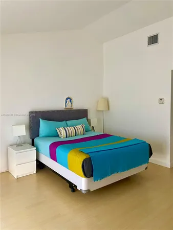 a bedroom with a bed and a table