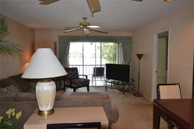 a living room with furniture and a lamp