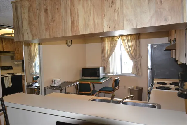 a kitchen with stainless steel appliances granite countertop a refrigerator and a sink