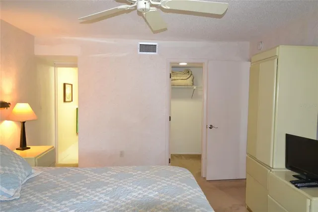 a view of an empty room with tv and wooden floor