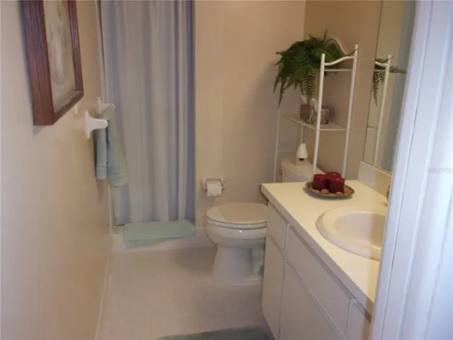 a bedroom with a bed and a mirror