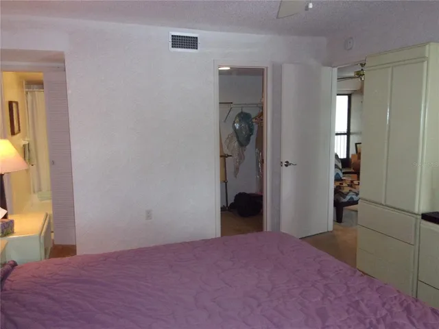 a bedroom with a bed and a chair