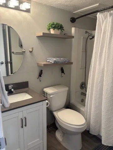 a white toilet sitting next to a bathroom sink
