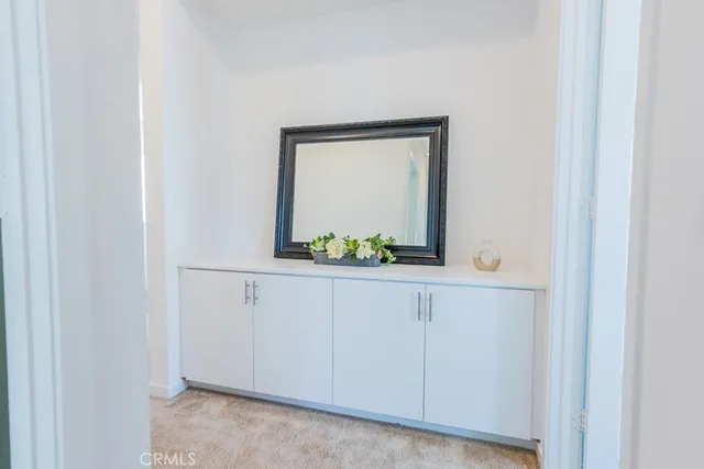 a bedroom with a bed lamp closet and window