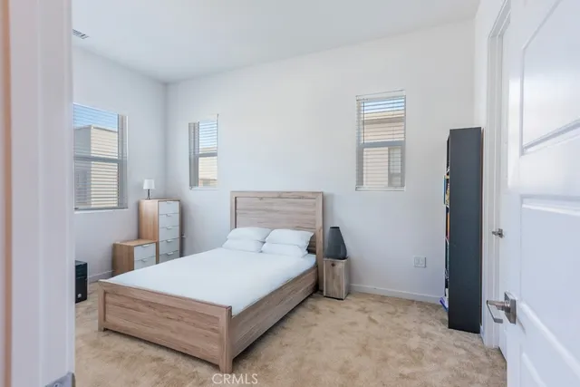 a room with a bed and a book shelf