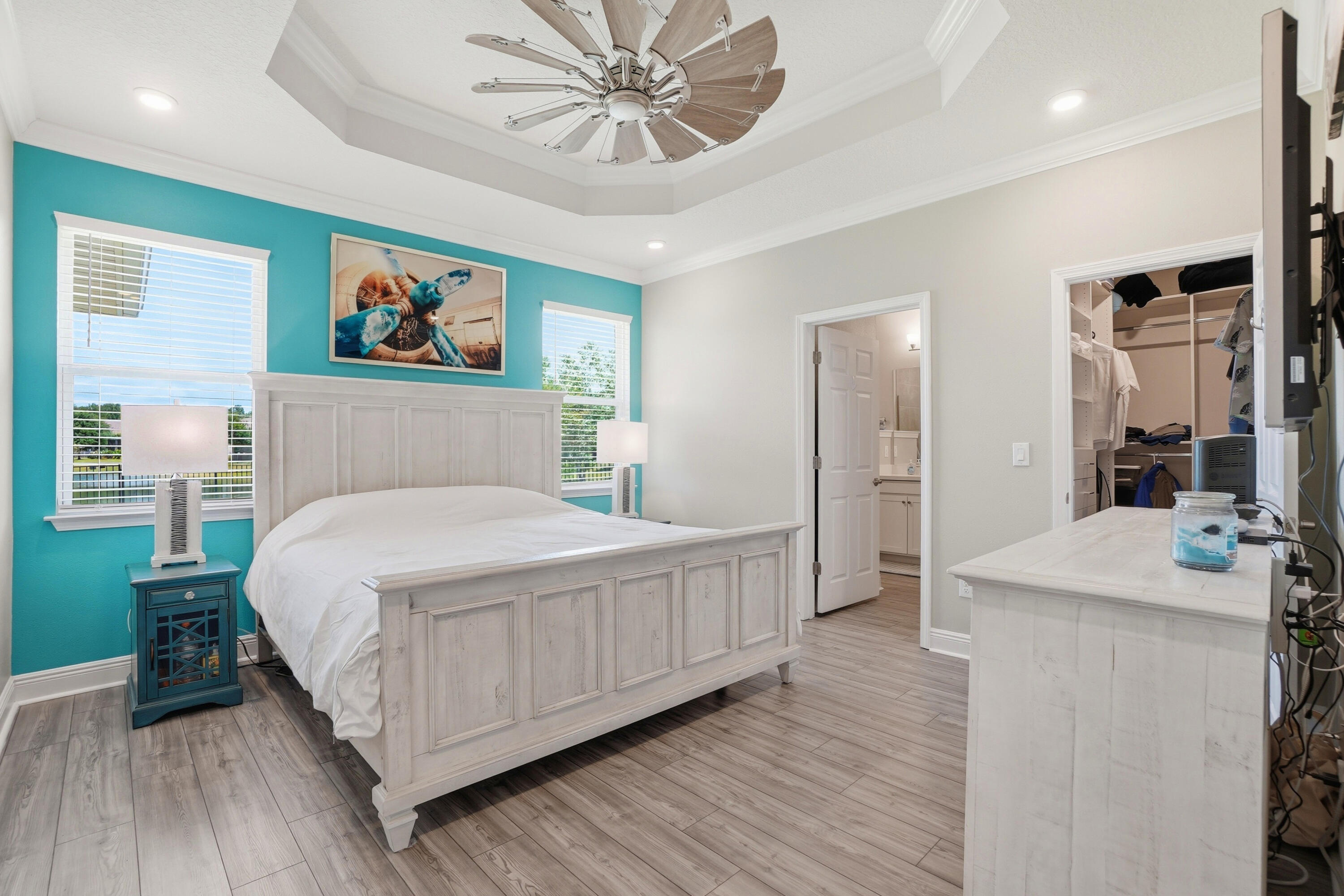 525 Windchime Way Freeport, FL 32439 - Photo 18 of 59 a bedroom with a large bed a chandelier and closet