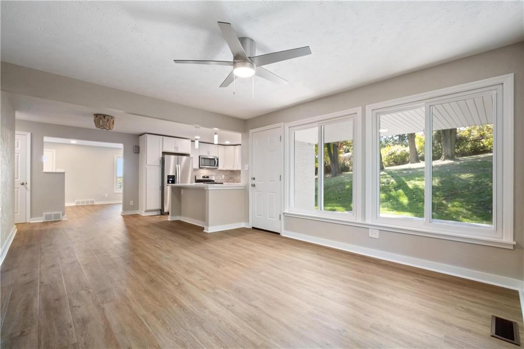 4786 Doyle Road Pittsburgh, PA 15227 - Photo 13 of 31 a view of a kitchen with wooden floor a ceiling fan and windows