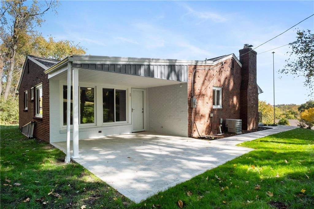 4786 Doyle Road Pittsburgh, PA 15227 - Photo 28 of 31 a view of a house with many windows and a yard