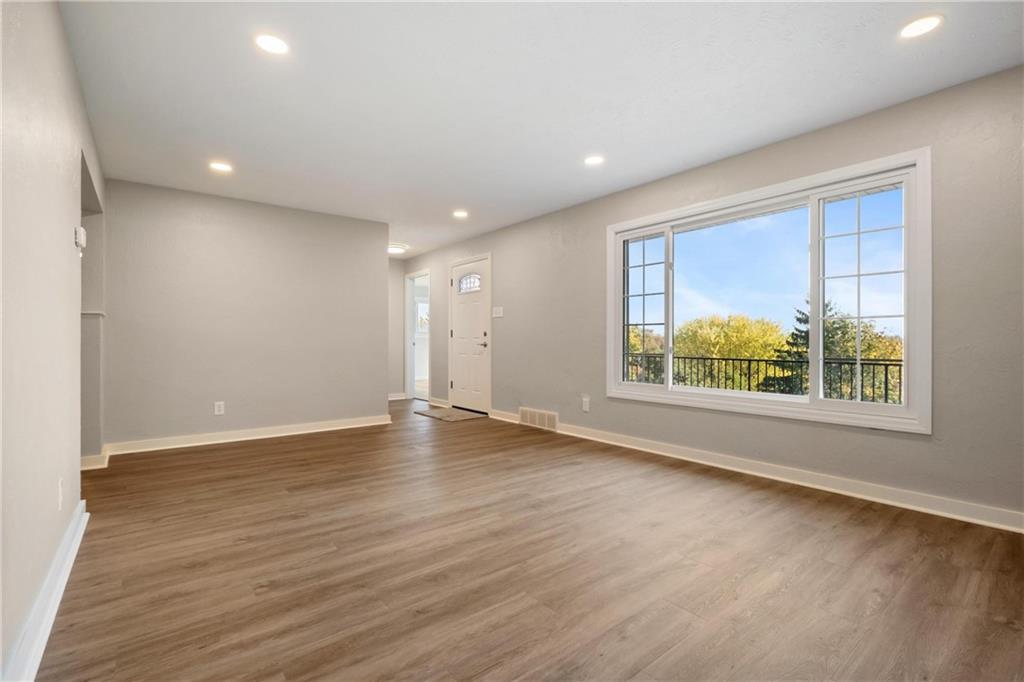 4786 Doyle Road Pittsburgh, PA 15227 - Photo 6 of 31 an empty room with wooden floor and windows