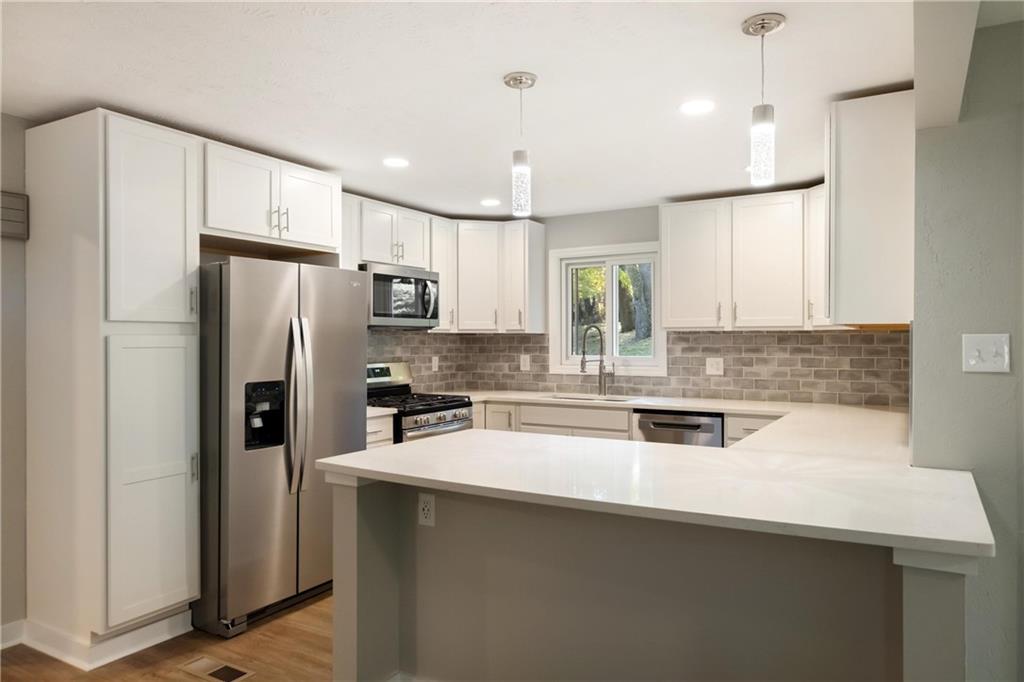 4786 Doyle Road Pittsburgh, PA 15227 - Photo 9 of 31 a kitchen with stainless steel appliances a refrigerator sink and microwave