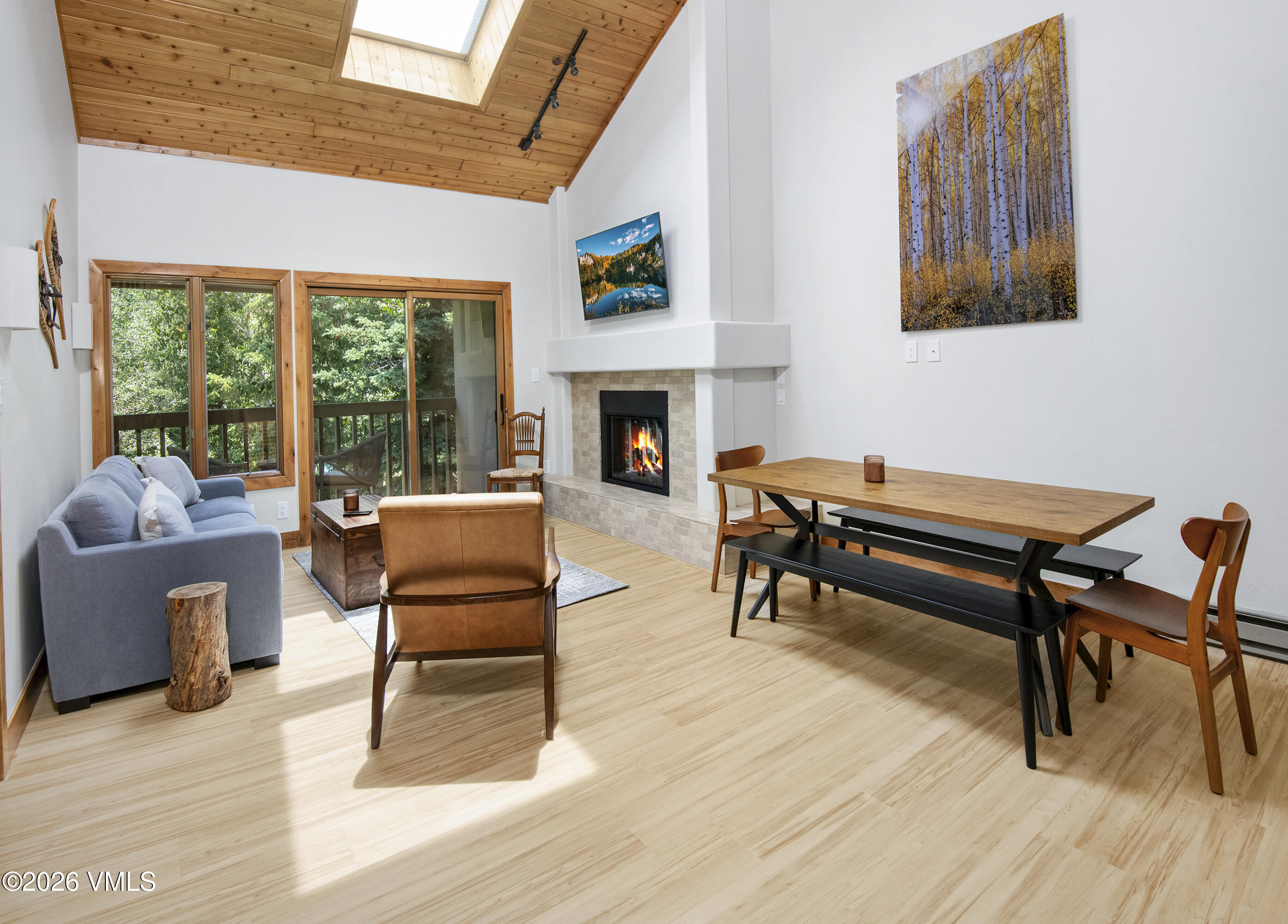 a living room with furniture a fireplace and a large window