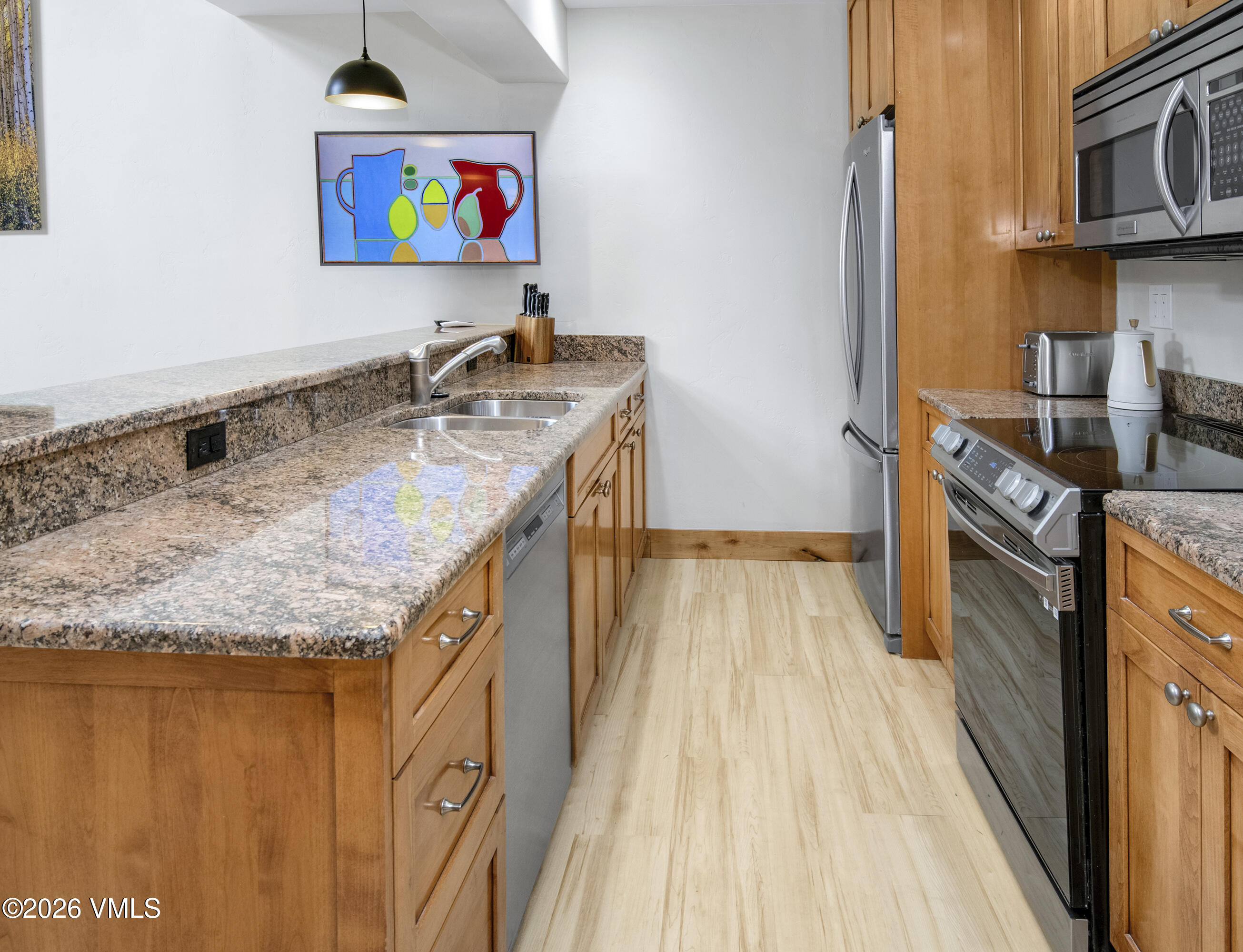 1206 Village Road, Unit B307 Beaver Creek, CO 81620 - Photo 4 of 20 a kitchen with stainless steel appliances granite countertop a stove and a sink