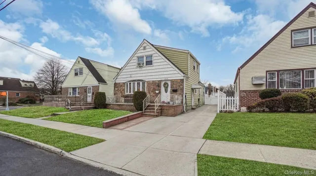 a view of a house with a yard and sitting area