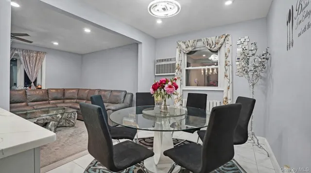 a view of a dining room with furniture and a kitchen