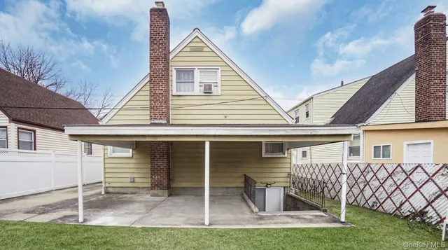 a view of house with backyard porch and sitting area