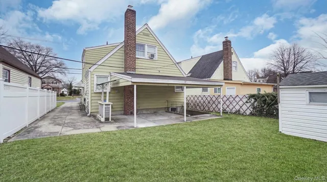 a view of a house with a yard and sitting area