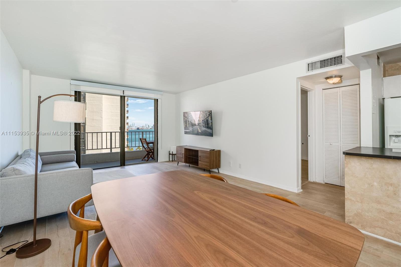 200 Southeast 15th Road, Unit 11H Miami, FL 33129 - Photo 11 of 20 a view of a livingroom with furniture wooden floor and windows