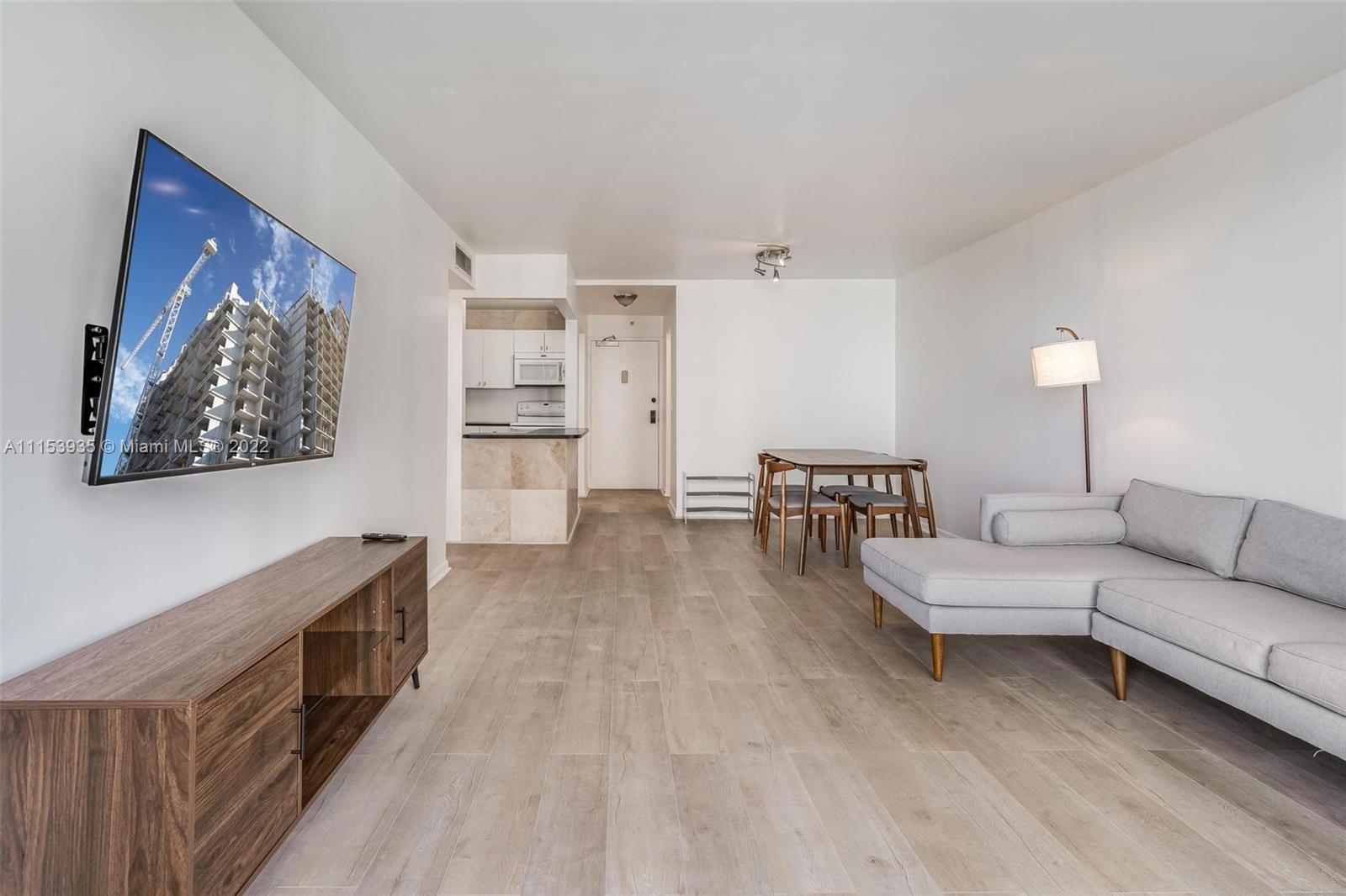 200 Southeast 15th Road, Unit 11H Miami, FL 33129 - Photo 12 of 20 a living room with furniture and a kitchen view