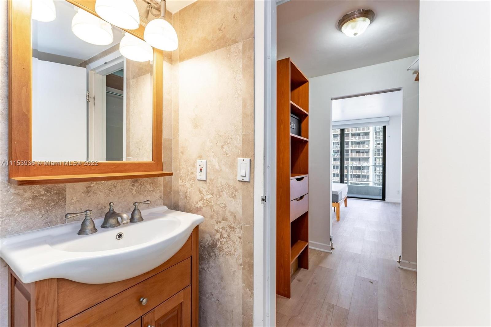 200 Southeast 15th Road, Unit 11H Miami, FL 33129 - Photo 16 of 20 a en suite bathroom with a sink and a mirror