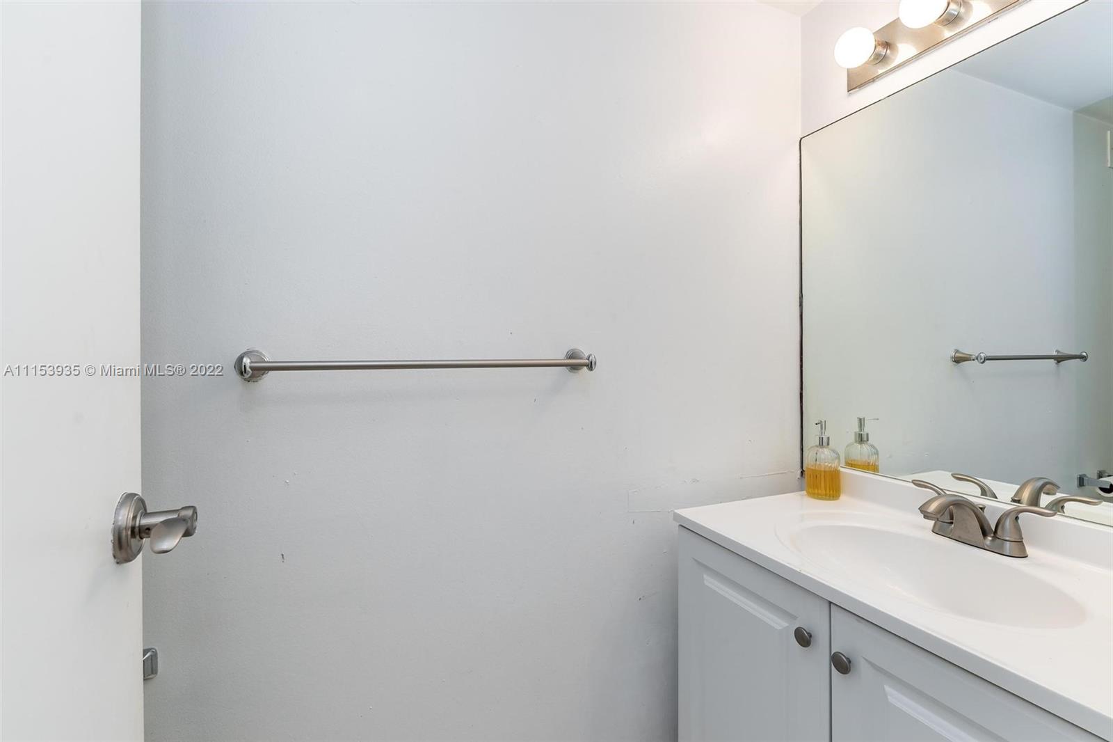 200 Southeast 15th Road, Unit 11H Miami, FL 33129 - Photo 18 of 20 a bathroom with a sink and a mirror